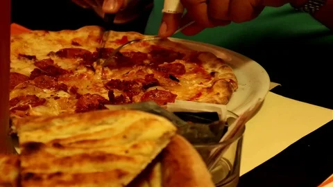 Cutting the pizza at the restaurant Stock Footage 112709128