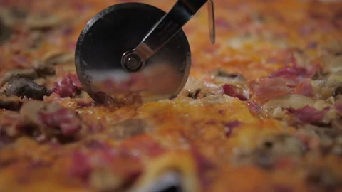 Cutting pizza with roller knife slow motion  Stock Footage 147441314