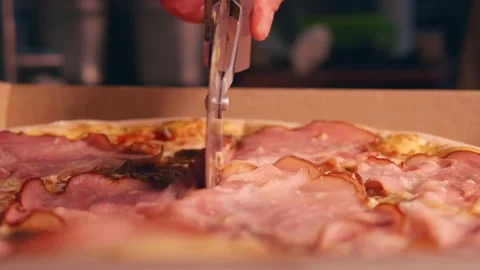 Cutting pizza with a round knife into even slices close-up Stock Footage 158403853