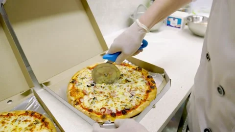 Cutting pizza with a specialized tool Stock Footage 151068730