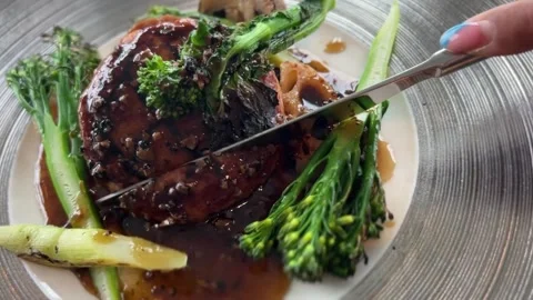 Cutting Plant Based Soy Meat Steak with Black Pepper Sauce and Broccoli Stock Footage 345964777