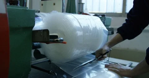 Cutting Plastic Off Roll in Factory Stock Footage 73075072