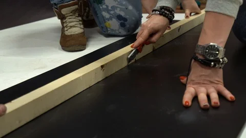 Cutting plastic sheet on the floor with blade, knife Stock Footage 101730202