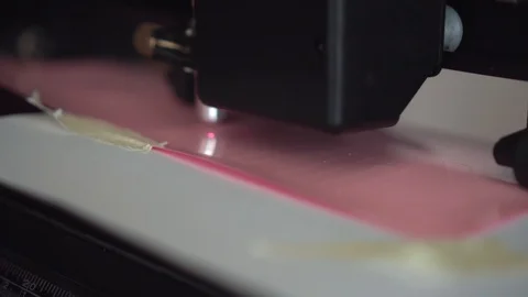 Cutting plotter. Plotter cuts vinyl, film. Laser cuts vinyl, film. Industrial Stock Footage 109480206