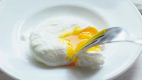 Cutting poached egg with yellow liquid yolk Stock Footage 131855744