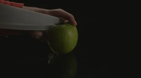 Cutting a polished green Apple Stock Footage 62640156