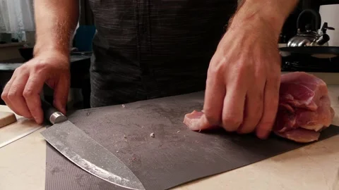 Cutting pork on a cutting board Stock Footage 135933543