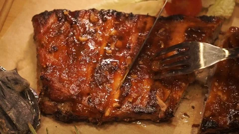 Cutting pork ribs on parchment Stock Footage 104851739