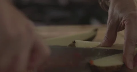 Cutting a potato on a chopping board Stock Footage 76412861