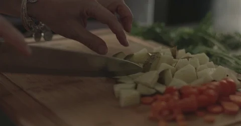 Cutting a potato on a chopping board Stock Footage 76412877