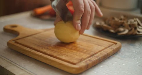 Cutting potato on the cutting board Stock Footage 87861533