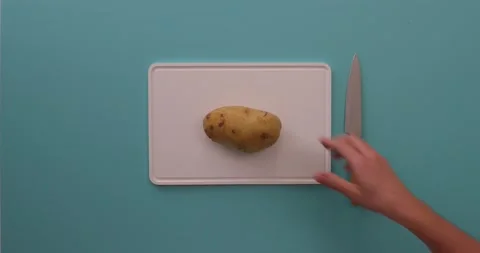 Cutting a potato in half 1 Video stock 132149167