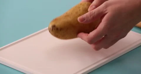 Cutting a potato in half 2 Stock Footage 132149199