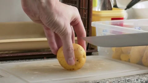 Cutting of potatoes on plastic board Stock Footage 142282306