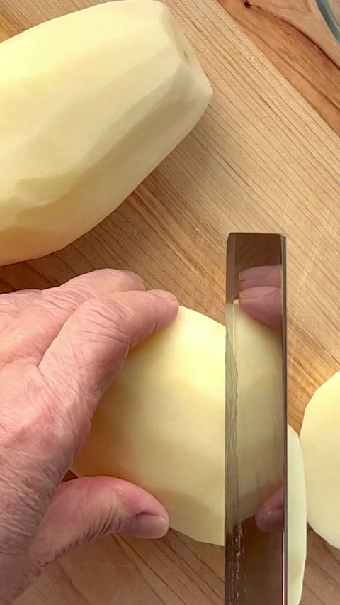Cutting potatoes into small pieces vertical Stock Footage 219238142
