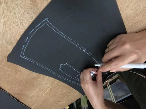 Cutting, preparing black leather or synthetic material for custom car interior Stock Photos