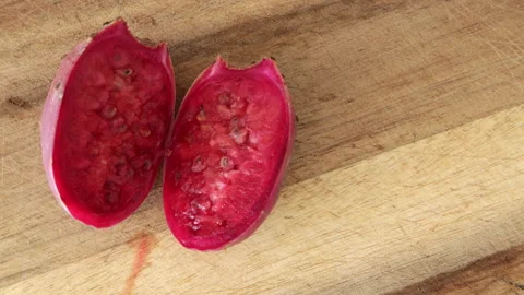 Cutting prickly pear cactus fruit opuntia on wooden board. Ficus indica close-up Stock Footage 316702900