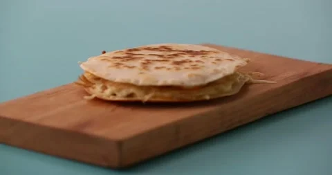 Cutting a quesadilla in half and then picking it up 2 Stock Footage 132203699