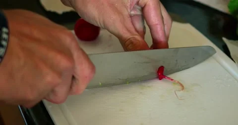 Cutting a radish on a cutting board in slow-motion Stock Footage 149180643