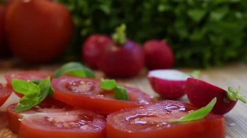 Cutting a radish in half, arranged among other fresh and healthy salad vegeta Stock Footage 166902108