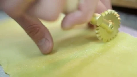 Cutting Raw and long pasta use a professional roller knife handmade, fresh egg Stock Footage 74718484