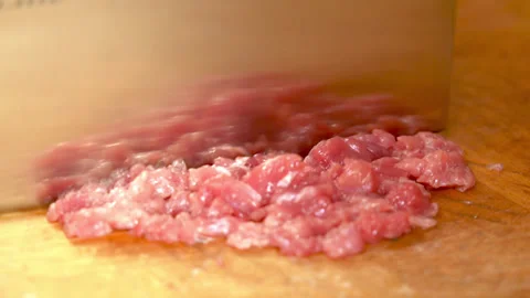Cutting raw beef on a cutting board closeup Stock Footage 250086278