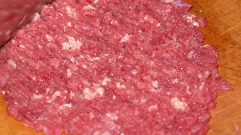 Cutting raw beef on a cutting board closeup Stock Footage 250086323