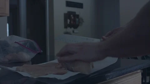 Cutting raw chicken breast with a kitchen knife. Stock Footage 86567144