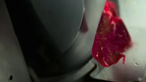 Cutting raw meat on slice machine for carpaccio slow motion сlose up HD video Stock Footage 70007034