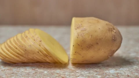 Cutting raw potatoes, close-up. Ripe, tasty potato vegetable Video stock 208672964
