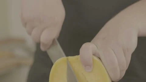 Cutting raw pumpkin slice. Man cutting an orange pumpkin piece. Stock Footage 90233132