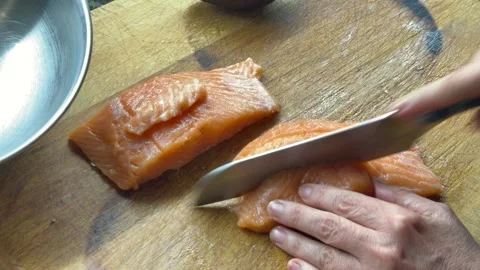 Cutting raw salmon into cubes for poke or tartar Stock Footage 333263121