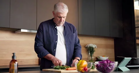 Cutting, recipe and old man with vegetables, cooking and confidence with tablet, Stock Footage 336855796