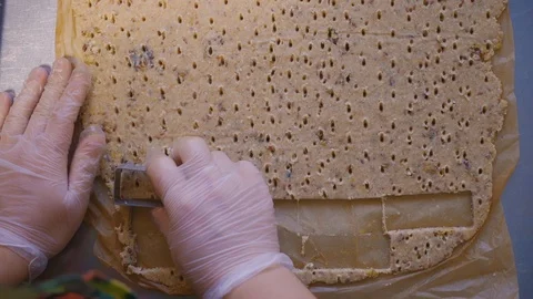 Cutting a rectangular cookie in the dough. Close-up on top Stock Footage 125956752
