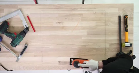 Cutting a rectangular shape from wooden board with electric saw Stock Footage 286079731