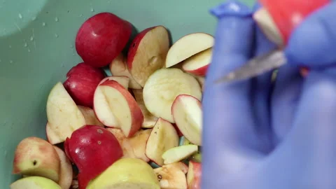 Cutting a red apple with a knife. Stock Footage 159425692
