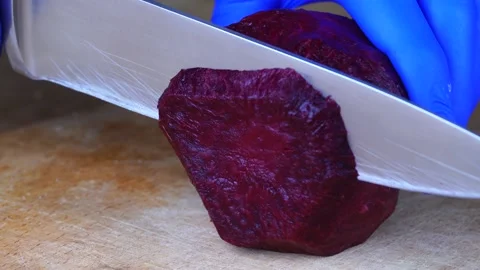 Cutting red beet root with knife. Close up of boiled beetroot Stock Footage 155566459