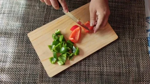Cutting Red bell pepper in a chopping board Stock Footage 166555220