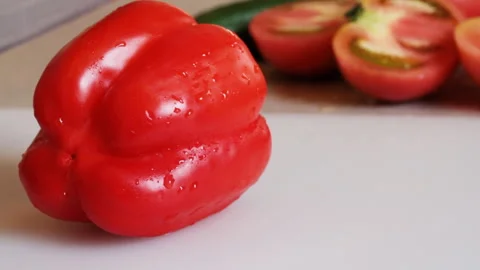Cutting a Red Bell Pepper in Half with a Knife Stock Footage 327588140