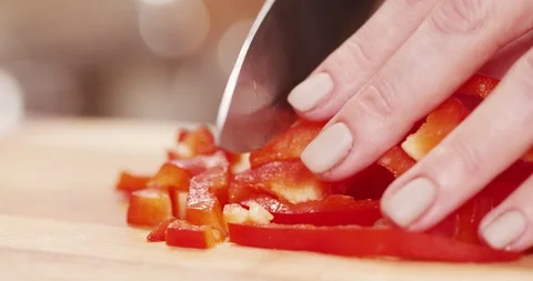 Cutting Red Bell Pepper with Knife on Wooden board Macro Closeup shot Stock Footage 124747373