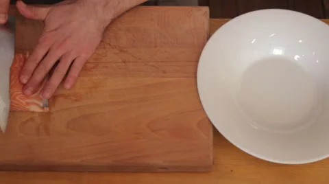 Cutting red fish, and putting on the plate Видео 58261945