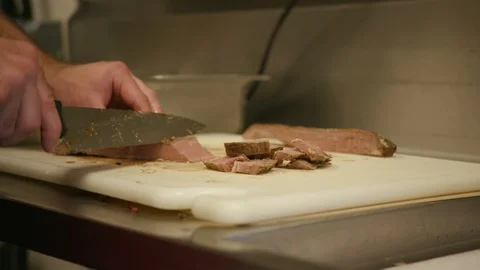 Cutting red meat with a knife Stock Footage 103883060
