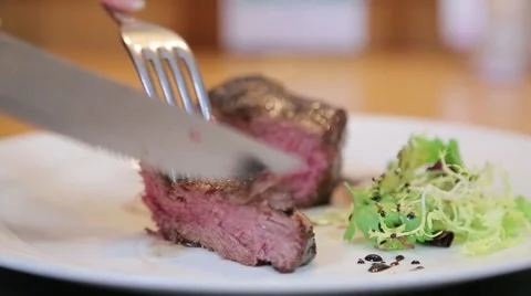 Cutting red meat on a plate close-up Stock Footage 61157958