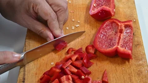 Cutting red pepper, on a table. In little pieces Stock Footage 219720595
