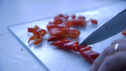 Cutting red peppers on a kitchen table Stock Footage 72559007