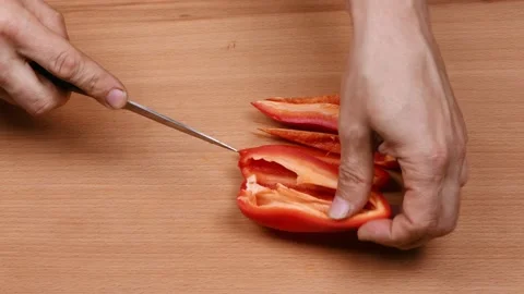 Cutting a red sweet pepper  with a knife. Healthy Food Concept. Stock Footage 239227258