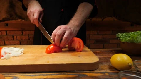 Cutting red tomatoes with a knife. Video stock 167059579