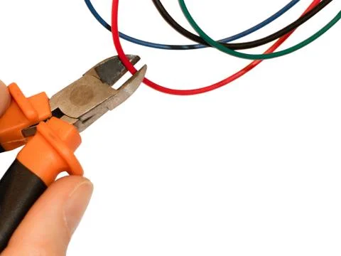 Cutting red wire by wire cutters. Safety precautions, bomb neutralization Stock Photos