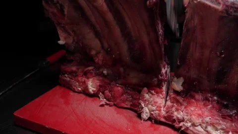 Cutting a rib eye 50fps Stock Footage 229937475
