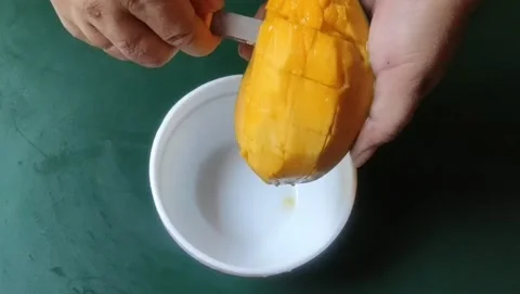 Cutting ripe mangoes Stock Footage 203901332